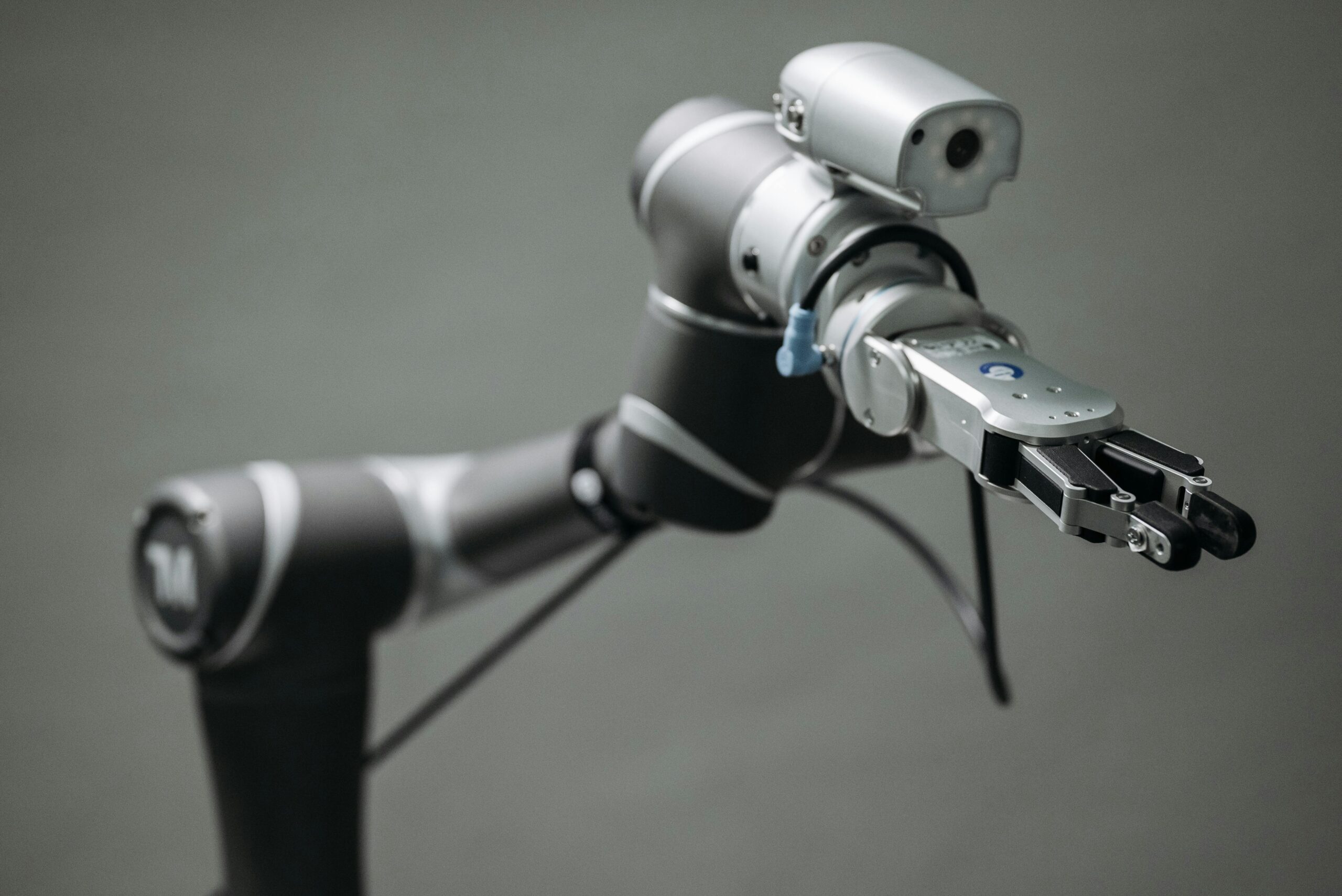 Home Close-up view of a robotic arm equipped with a video camera, showcasing modern technology.